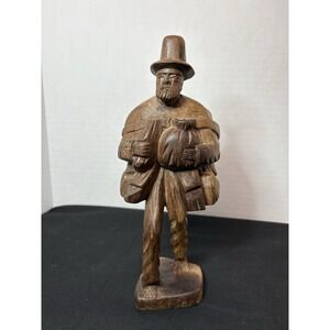 vintage, hand-carved wooden sculpture of a traveling man